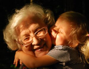 grandmother hugging granddaughter profile pic